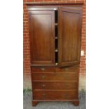 A Regency inlaid and crossbanded mahogany linen press, with three slides, over a chest base