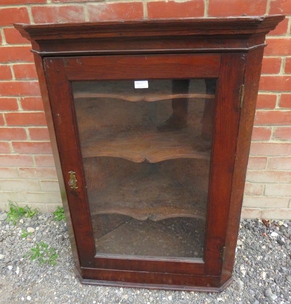 A 19th century oak wall hanging glazed corner cupboard with three shaped shelves. 102cm high x