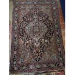 An early-mid 20th Century Persian rug (Iraq). 152cm x 102cm. Some wear to edges. Colour good.