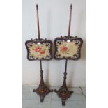 A pair of 19th century mahogany pole screens with tapestry panels raised on baluster turned pedestal