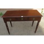 An Edwardian mahogany writing desk with three frieze drawers with brass drop ring handles, raised on