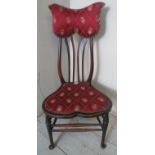 A turn of the century Art Nouveau bedroom occasional chair with unusually shaped back rest and