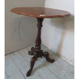 A Victorian mahogany wine table with a shaped top over a balluster column and scrolled tripod