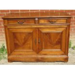 A vintage French fruitwood sideboard with two cutlery drawers over twin cupboard doors opening