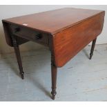 A 19th Century mahogany drop leaf Pembroke table with a single drawer to one end over turned legs.