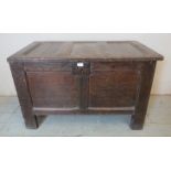 An 18th century oak coffer of small proportions carved with the initials 'T'S', raised on style
