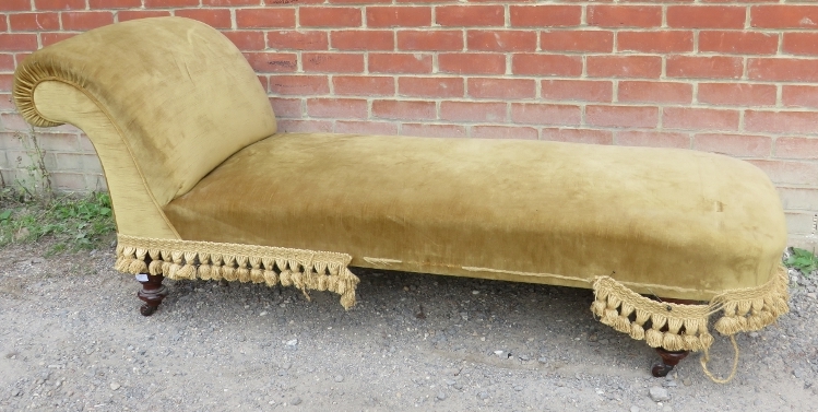 A 19th century chaise longue upholstered in gold draylon, raised on tapering turned supports with