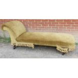 A 19th century chaise longue upholstered in gold draylon, raised on tapering turned supports with
