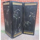 An early 20th century bamboo three section folding screen, ebonised and hand painted with depictions