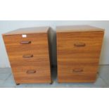 A pair of teak effect post war filing cabinets raised on castors. cm high x cm wide x cm deep (