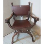 A vintage mahogany Savonarola chair ornately carved with grotesque mask finials & armrests, raised