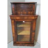 A Victorian rosewood chiffonier cabinet with glazed door opening onto two gold velvet wrapped