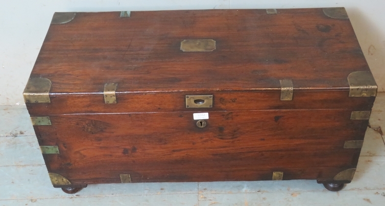 A 19th century oak brass bound campaign chest with internal candle holder box, raised on bun feet.