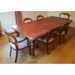 A reproduction Victorian style extending dining table, with 8 (6+2) matching balloon back chairs.