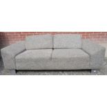 A good quality contemporary two seater sofa upholstered in a grey fabric and terminating on chrome