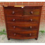 A Victorian flame mahogany bow fronted chest of two short over three long graduated cock beaded
