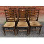 A set of six vintage oak framed ladder back dining chairs with rush seats, raised on tapering