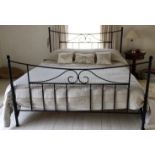 A bespoke wrought iron super king size bed complete with side rails and wooden base slats. Condition