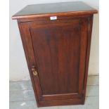 An early 20th century oak pot cupboard with green vinyl insert to top and two internal fitted