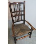 A 19th Century country oak framed rush seated elbow chair. Condition report: Age related wear to