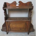 An Arts & Crafts wall hanging shelf with single cabinet. 60cm high x 70cm wide x 15cm deep (approx).