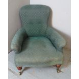 A 19th century Howard style low armchair by Hindley & Sons of Oxford Street, raised on tapering