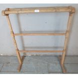 A antique pine single towel rail. 84cm high x 66cm wide x 30cm deep (approx).