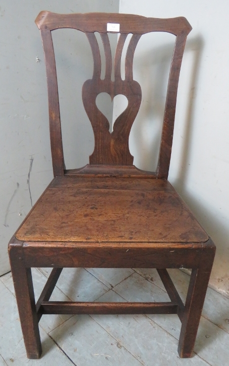 An 18th century oak hall chair with a shaped & pierced back splat depicting a love heart, possibly