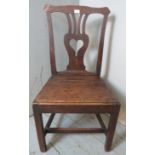 An 18th century oak hall chair with a shaped & pierced back splat depicting a love heart, possibly