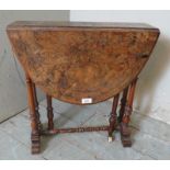 A Victorian oval walnut Sutherland table strung with satinwood and raised on turned supports. 53cm