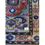 A mid 20th Century Turkish Konya carpet with central medallion motif and wide triple borders.