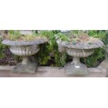 A pair of reconstituted garden planters in the Grecian style. 33cm high x 42cm wide x 42cm deep (
