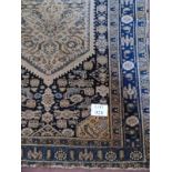 An early-mid 20th Century Persian wool rug, cream/blue. 135cm x 198cm. Condition report: Overall