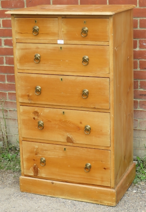 A tall pine chest of two over three long drawers with brass drop ring handles, raised on a plinth - Image 2 of 2