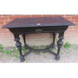A 19th century carved oak side table in the Flemish taste, with single frieze drawer, raised on