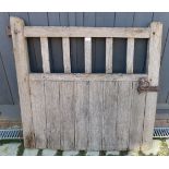 A nicely weathered oak framed gate complete with hinge and latch.