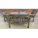 A weathered slatted teak patio table with two benches and two chairs. 75cm high x 150cm wide x