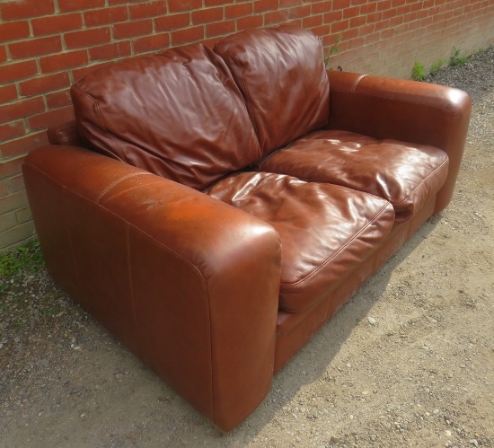 A contemporary two seater sofa upholstered in brown leather. 82cm high x 180cm wide x 102cm deep ( - Image 2 of 2