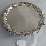 A Georgian C18th silver card tray with shell and scallop rim on 3 hoof feet. Rubbed mono to