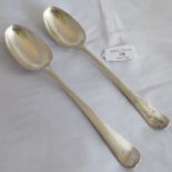 A pair of early Hester Bateman serving spoons, London 1776, having foliate decoration to the spoon
