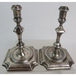 A pair of George I silver candlesticks believed to be by James Gould, London 1724, having flared