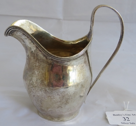 A Georgian silver helmet shaped cream jug with reeded pattern to handle and rim. London 1803, makers - Image 2 of 6