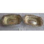 A pair of large silver embossed bon bon dishes, marked sterling to bases, probably early 20th
