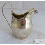 A Georgian silver helmet shaped cream jug with reeded pattern to handle and rim. London 1803, makers