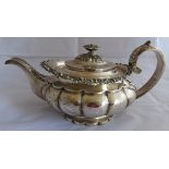 A decorative Georgian silver 2 pint teapot on circular scalloped base and have foliate and