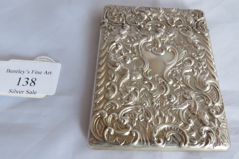 A silver card case embossed with cherubs and scrolls. London 1896, maker William Gibson & John