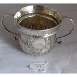 An early C18th George II silver porringer with half fluted body. Mono to cartouche. London 1727,