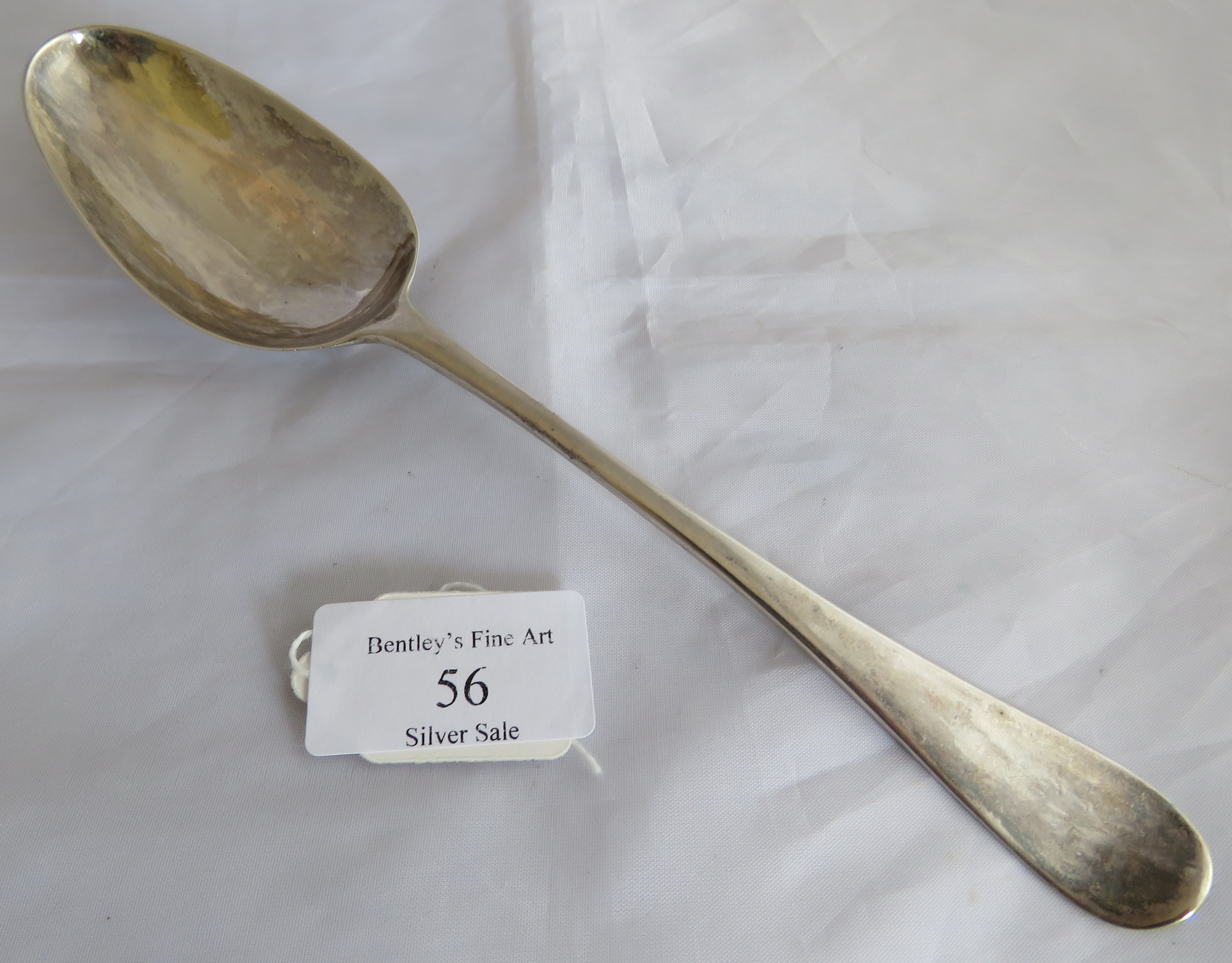 A silver George III tablespoon with shell to back of bowl. London 1767, maker WT. Weight 57 grams,