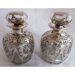 A pretty pair of late C19th/early C20th clear glass and silver overlay bulbous form scent bottles