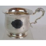 A George III silver half pint mug of squat baluster form with acanthus leaf scroll handle and